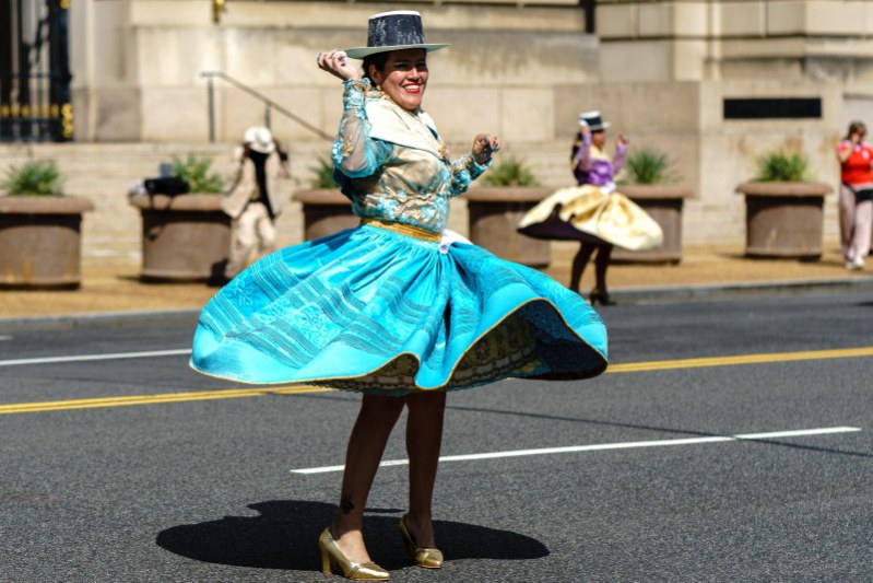 Dancer spinning in turquoise traditional dress
